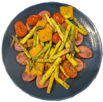 Sliced browned keilabasa with roasted asparagus, grape tomatoes, and orange bell peppers.