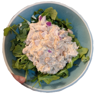 Tuna and white bean salad on a bed of arugula.